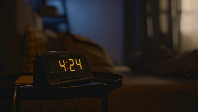 No people shot of digital clock on bedside table in darkened room at half past four in early morning, copy space