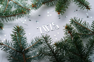 Abstract light Christmas background with stars and a Christmas tree with the year number 2025.