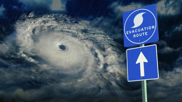 A shaking hurricane evacuation route directional road sign above a stormy and rainy cloudscape background.  	