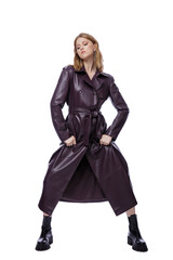 Fototapeta premium High fashion photo of a beautiful elegant young woman in pretty long purple lilac leather jacket, coat posing on white background. Slim figure. Blonde