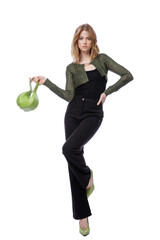 High fashion photo of a beautiful elegant young woman in pretty black denim pants, trousers, top, green short jacket, handbag posing on white background. Slim figure. Blonde