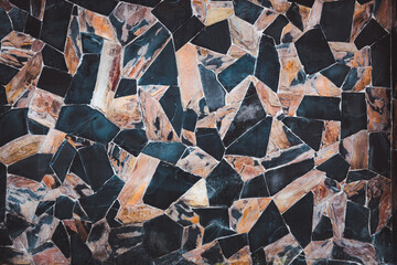 A black and brown mosaic tile pattern with a brown and black border