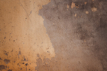 A wall with a brown and tan color and some paint on it