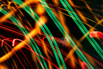 The image is a colorful abstract of a car with green, red, and orange lines