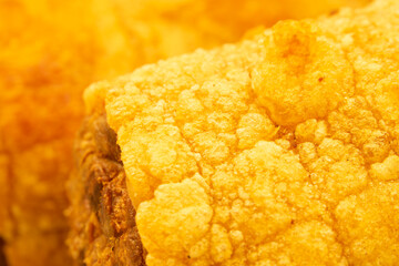 A piece of fried food with a crispy texture and a golden color