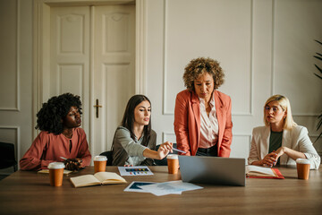 Shot of a group of colleagues having a meeting in a modern office. Mature CEO running a meeting