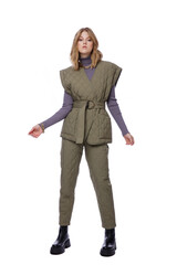 Fototapeta premium High fashion photo of a beautiful elegant young woman in pretty green pants, trousers, purple blouse, jacket posing on white background. Slim figure. Blonde