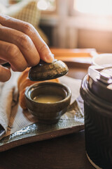 Close up of woman hands making a simple tea.