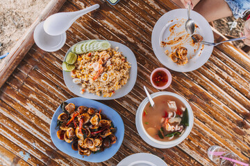 Lunch set of Thai seafood served on local restaurant bamboo table.