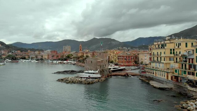 Aerial view of Carlo Riva Marina destroyed by powerful storm. Extreme disaster aftermath, sunken yachts and boats, piles of debris, catastrophic weather events damage. Rapallo, Italy.