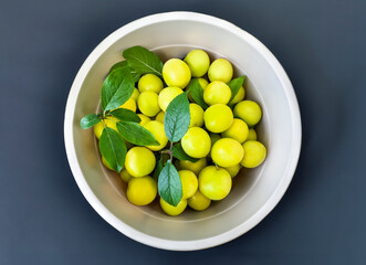 Yellow cherry plum in a bucket