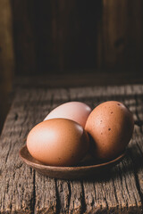 Hen eggs on rustic wooden background