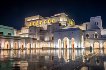 Fototapeta premium Modern building of Royal Opera House illuminated at night, Muscat, Oman