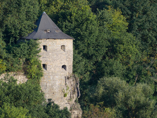 Old stone tower in the forest. Architecture in a medieval city.