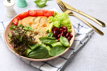 Healthy meal. Tasty vegetables, quinoa and chicken breast in bowl on white table