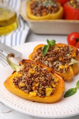 Quinoa stuffed peppers with corn and basil on white textured table, closeup