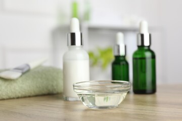 Peeling procedure. Bottles of chemical peel and bowl with liquid on wooden table indoors