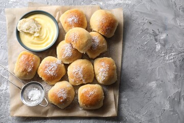Delicious dough balls and sauce on grey table, top view