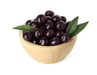 Fresh ripe acai berries in bowl and green leaves isolated on white