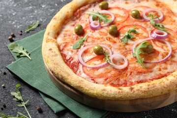 Delicious vegetarian pizza, arugula and peppercorns on black table, closeup