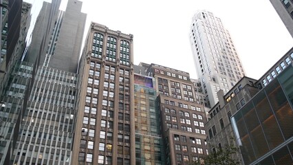 Fototapeta premium New York City Manhattan Midtown building architecture, urban street in United States. Residential houses with apartments on 42 street near Broadway and Bryant Park, real estate property in USA. Realty