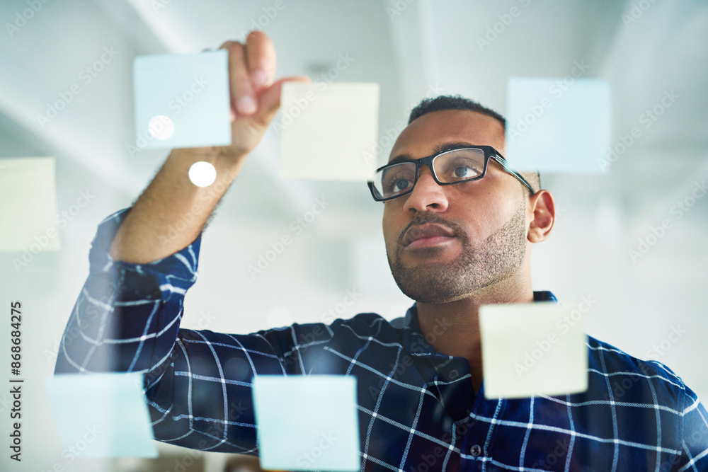 Poster brainstorming, sticky note and black man on glass wall for business, schedule or planning startup id