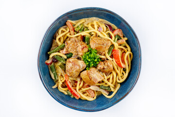 Egg noodles with curry sauce and chicken on a white background