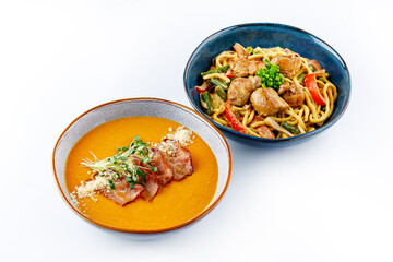 Soup and noodles in bowls on a white background, food on a white background