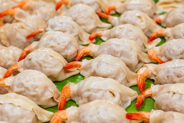 Thai strret food on night market. Close up of tray with shrimp dumplings. Asian food in Bangkok, Thailand. Chinese cuisine