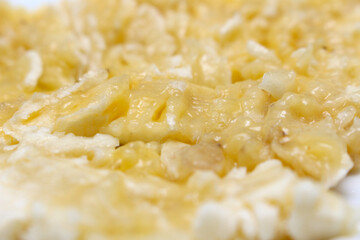 Crushed banana. mashed banana with selective focus. details of the meal. crushed yellow fruit.