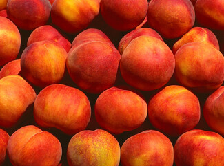 Close up view of a box of ripe peaches on a market stall