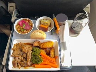 Hot meal in an airline's business class cabin.