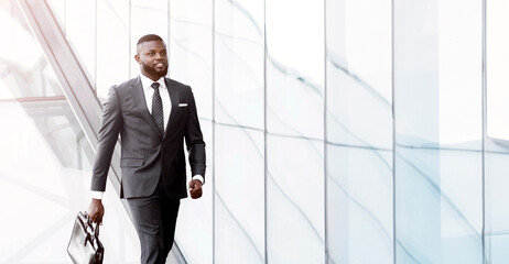 Business Lifestyle. Successful African Entrepreneur In Suit Walking With Briefcase In Urban City Area Outside. Full-Length, Empty Space