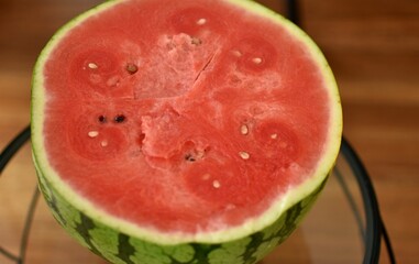 half of a ripe red watermelon on a glass table