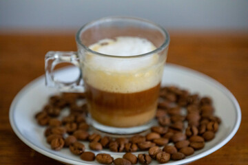 Espresso coffee served in a transparent cup with roasted coffee beans. Gourmet, 100% Arabica special