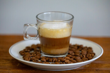 Espresso coffee served in a transparent cup with roasted coffee beans. Gourmet, 100% Arabica special