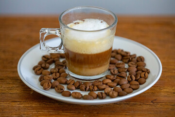 Espresso coffee served in a transparent cup with roasted coffee beans. Gourmet, 100% Arabica special