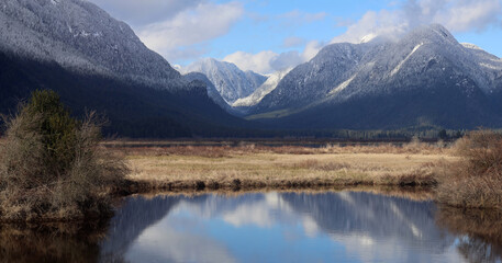 Perspective with first winter snow on valley mountains