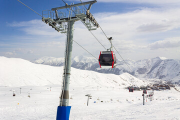 Gudauri Ski Resort: Gondola (Ski Lift) and Snow-covered Caucasus Mountains in Distance - Gudauri, Georgia © яна винникова
