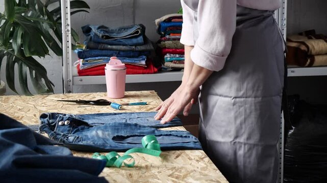 DIY and upcycling old jeans. Hand at home repair. Darning or applying a patch. Sustainable living
