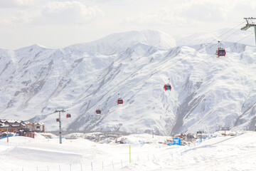 Gudauri Ski Resort: Gondola (Ski Lift) and Snow-covered Caucasus Mountains in Distance - Gudauri, Georgia © яна винникова