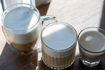 Sparkling latte in glass crystal glass on wooden table