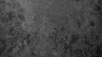 A black wall with a lot of cracks and holes. The wall is made of concrete and has a rough texture