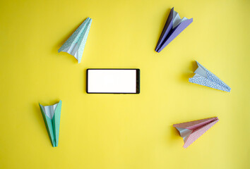 paper airplanes chaotically circle around the phone. abstraction on the theme of messages and...