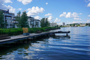 Fototapeta premium Scenic view of river by buildings against sky