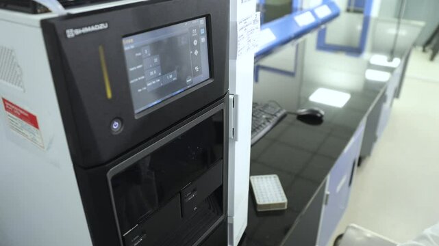 hplc science experiment Vials filling inside an autosampler of an HPLC machine inside view in a Scientific experimental laboratory for research development analysis and clinical trial study	