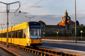 Scenic Dresden cityscape yellow tram crossing Carola bridge Elbe river Saxony State Chancellery...