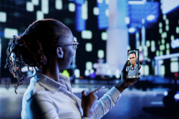 Woman in videocall with boyfriend while strolling around city streets at night, talking about her day. Citizen using smartphone to show partner surroundings in dimly illuminated town center