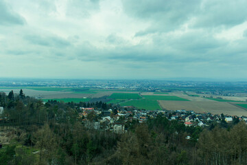 Obraz premium Landscape captured from a vantage point. A vast landscape under a dramatic sky with clouds. Top view landscape, sky with clouds.