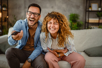 Adult couple boyfriend and girlfriend watch movie with popcorn at home